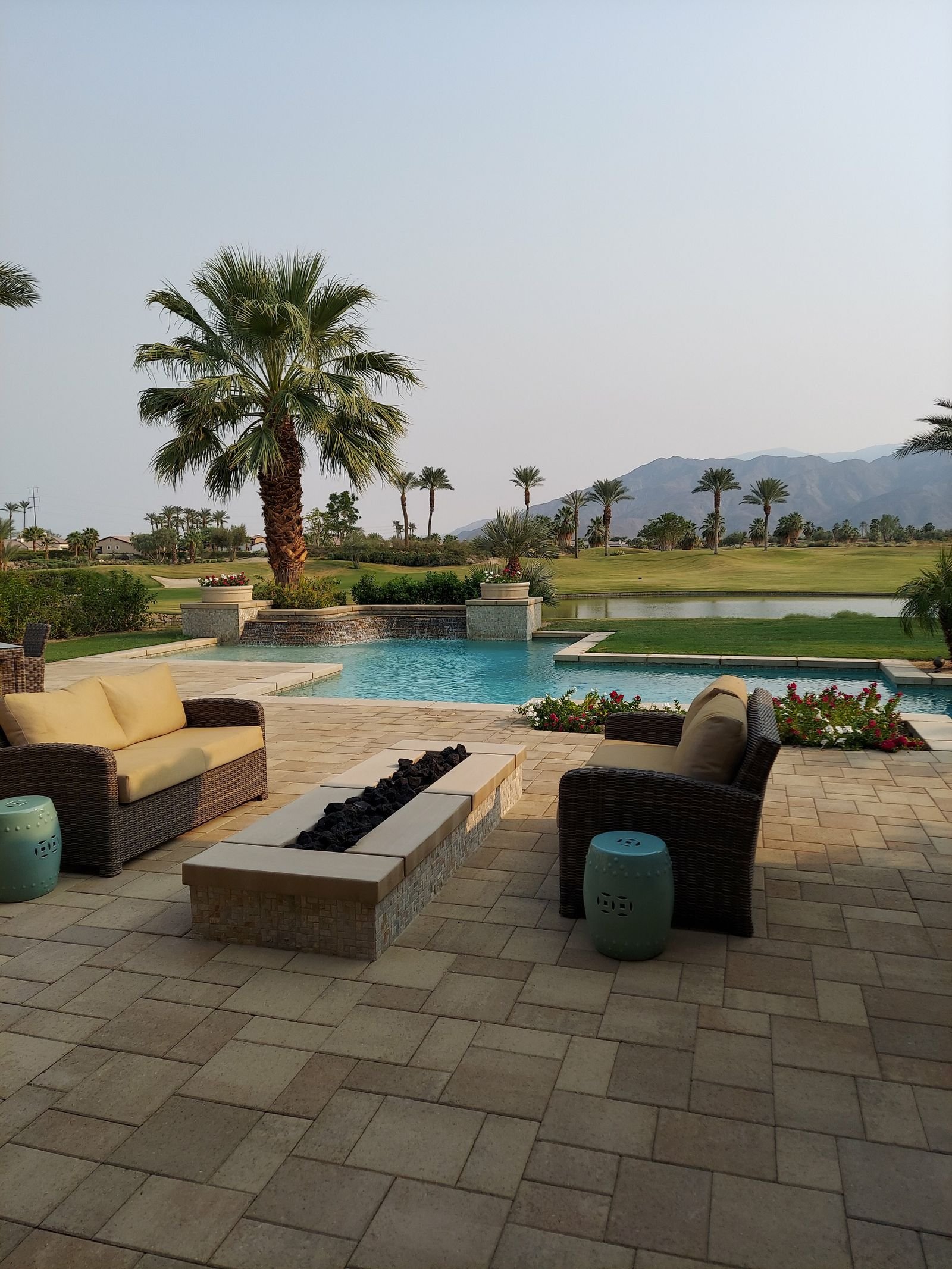 Paver pool deck and patio with outdoor seating at a Florida home